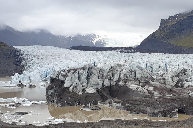 2-Day Highlights of Iceland | Land of Ice & Fire-Small Group Tour - Day one: waterfalls, glacier ice, and the black-sand coast
