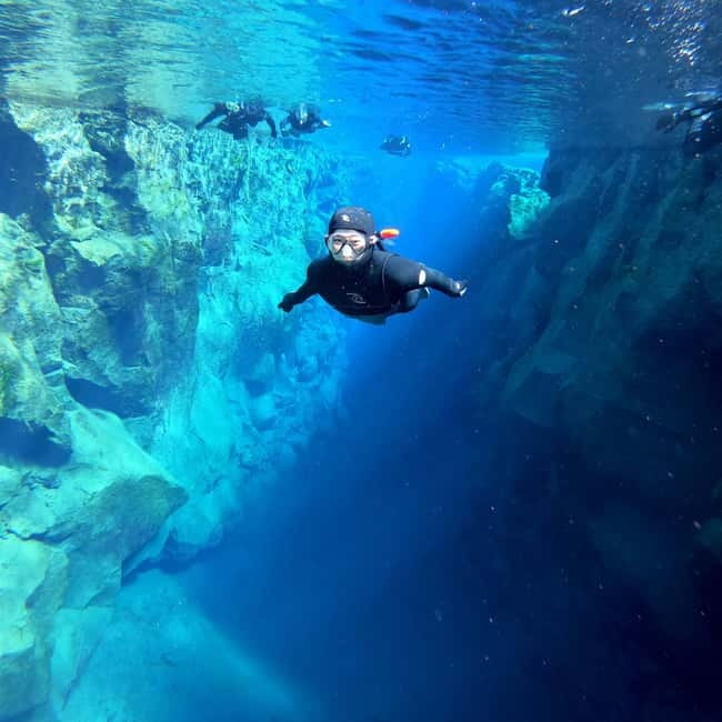From Reykjavik: Silfra Snorkeling with Free Photos - Getting into the water in a drysuit or wetsuit